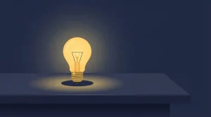 Leuchtende Glühlampe über einer dunklen Tischfläche